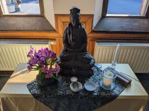 Zen altar in the morning light. Kanzeon in the center, with flowers, candle light, water and lavender offerings. All is fresh and new!